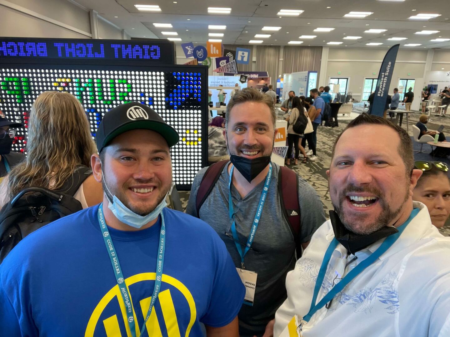 Three men taking an usie in the WCUS Sponsor Hall