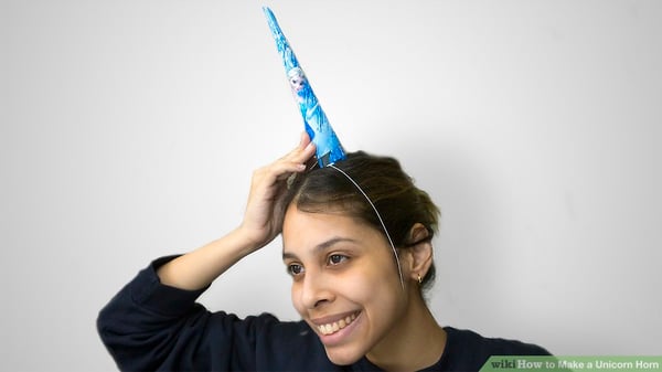 Woman wearing a unicorn horn for office Halloween party