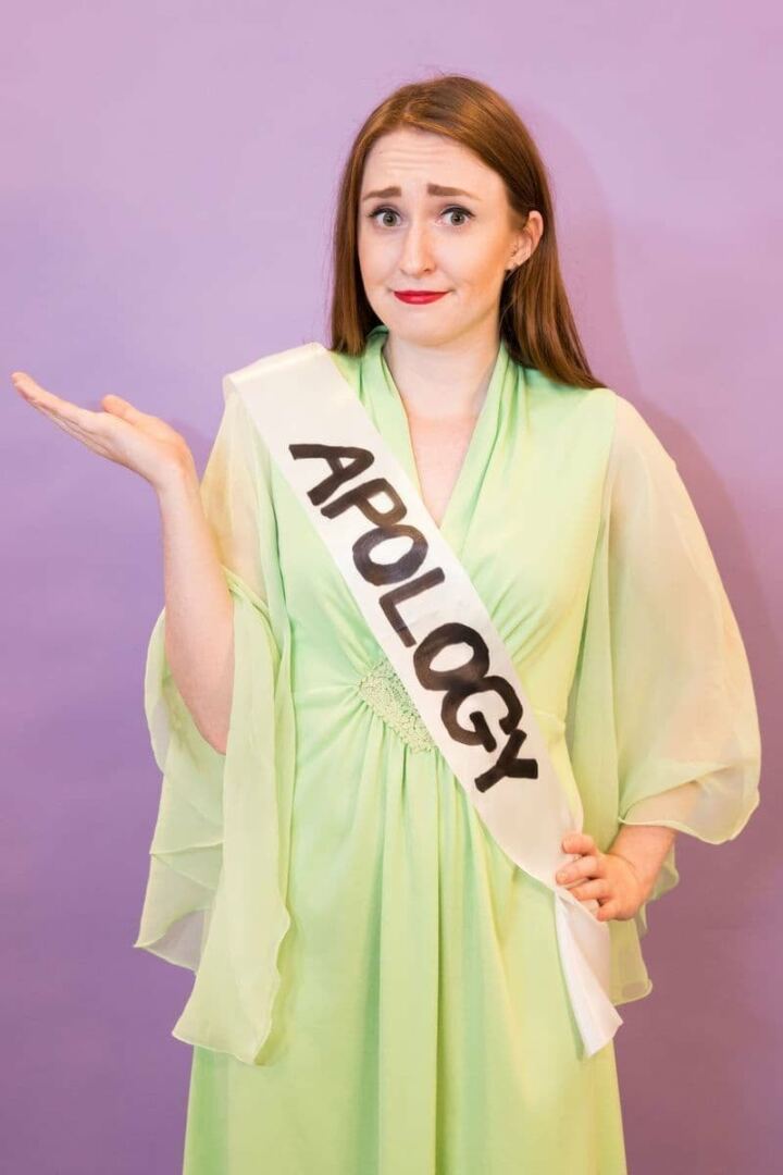 Woman wearing formal gown with a sash that says 