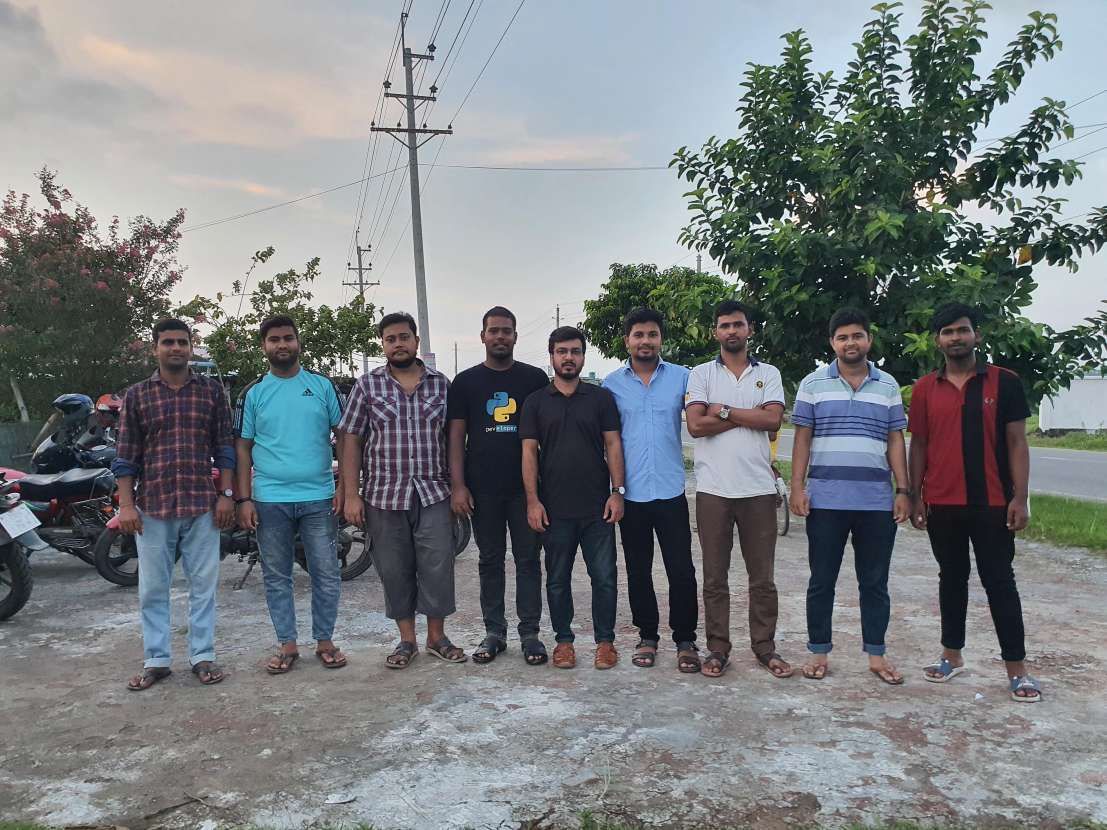 9 men standing outside at the Divi Satkhira meetup