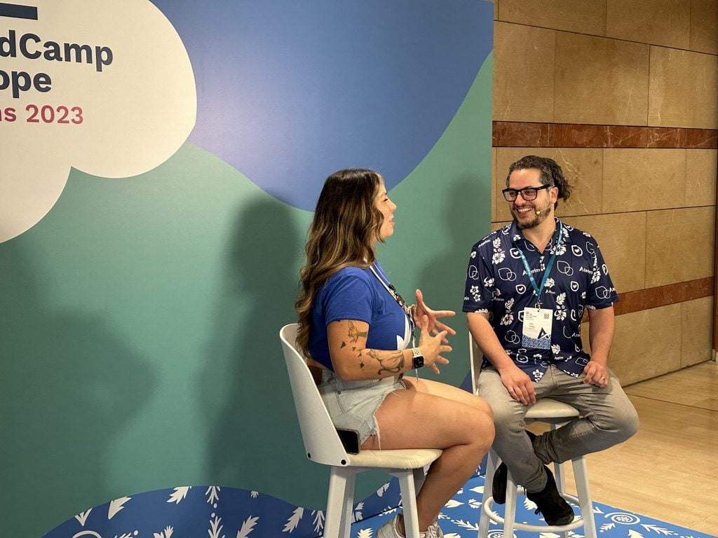 Raquel interviewing Vito Peleg. both sitting on hightop chairs