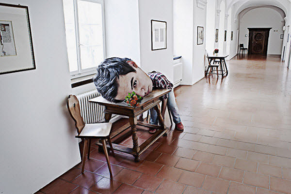 A man with an oversized head in a hospital setting