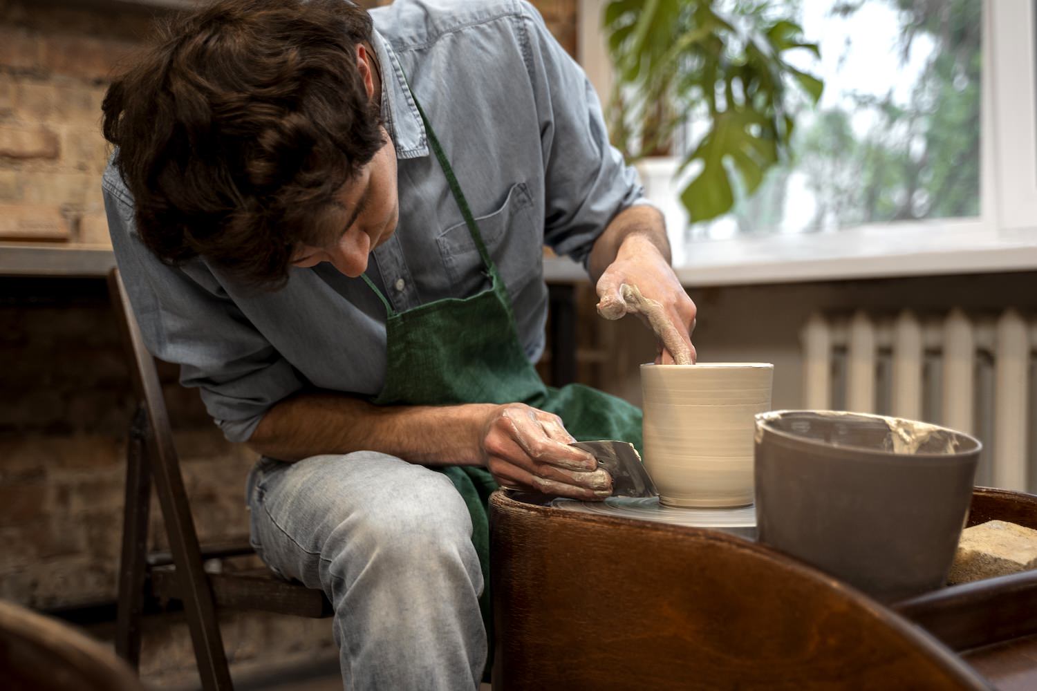 man doing pottery