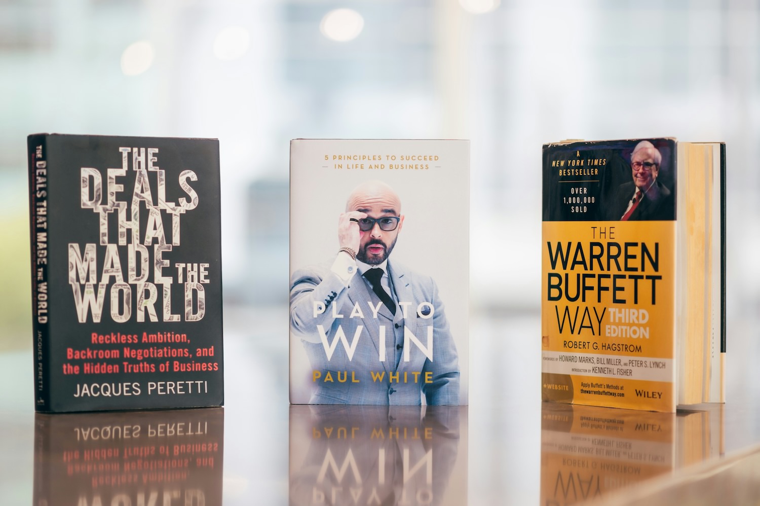 stack of business books on a desk