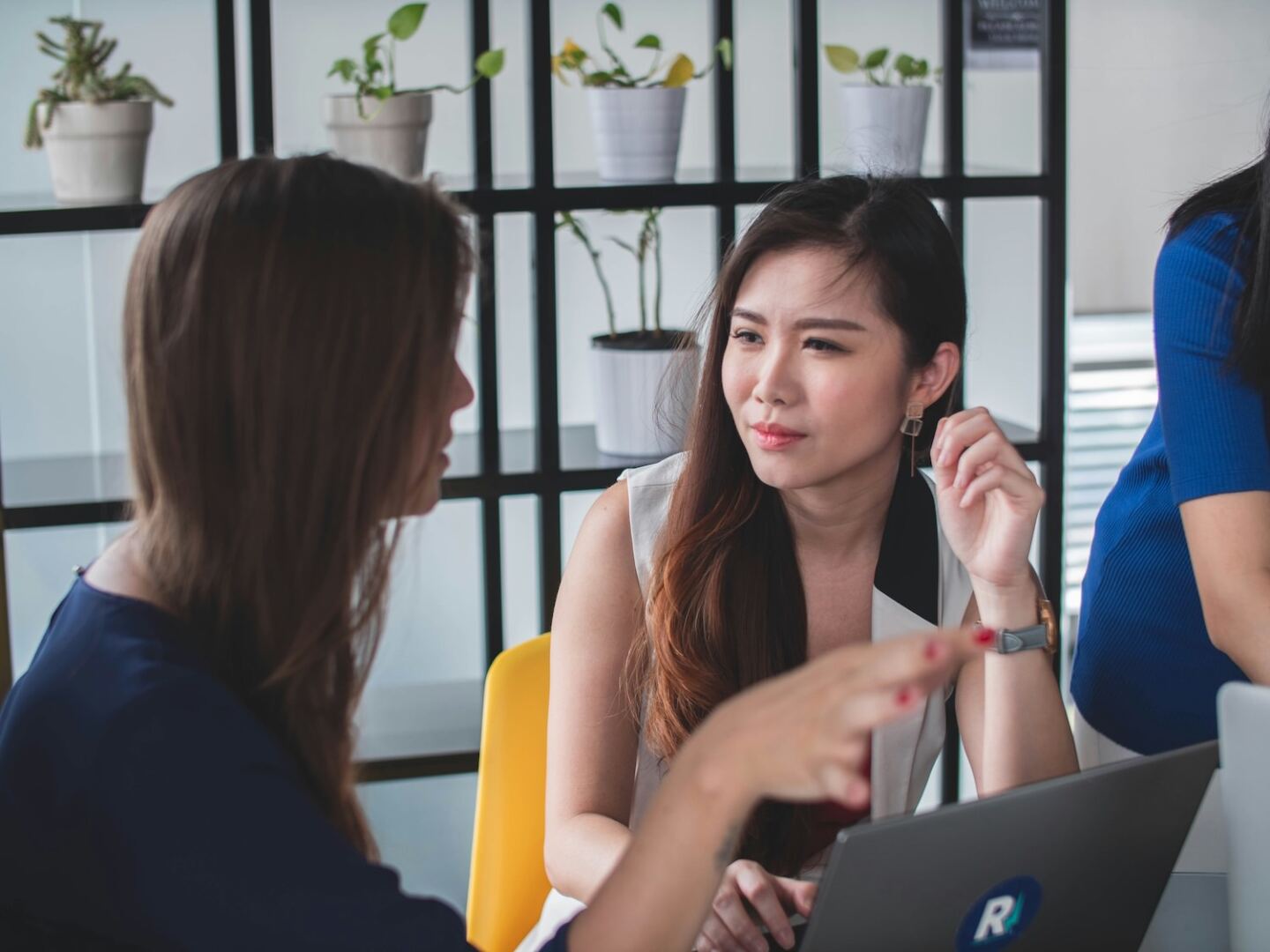 two women engaging in respectful conversation while listening attentively